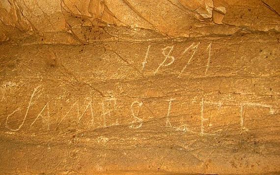Photo of graffiti carved into the cave wall
